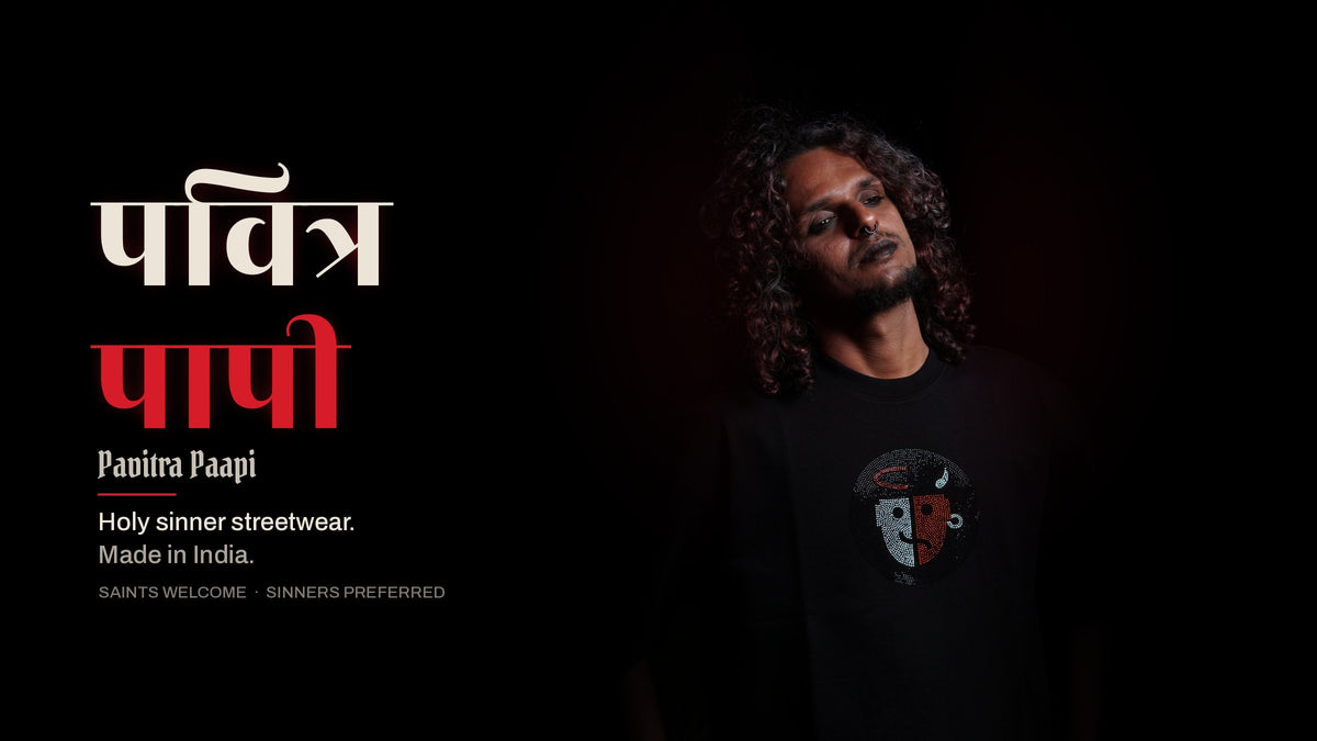 Pavitra Paapi model in a black oversized tee with the rhinestone saint and sinner face